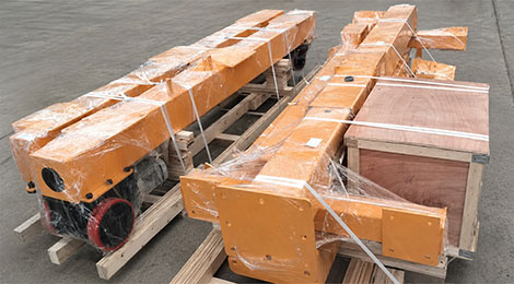 Gantry beam, legs, casters and parts box strapped to wooden skids