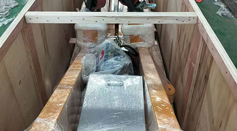 Open plywood case with gantry parts braced inside, casters visible