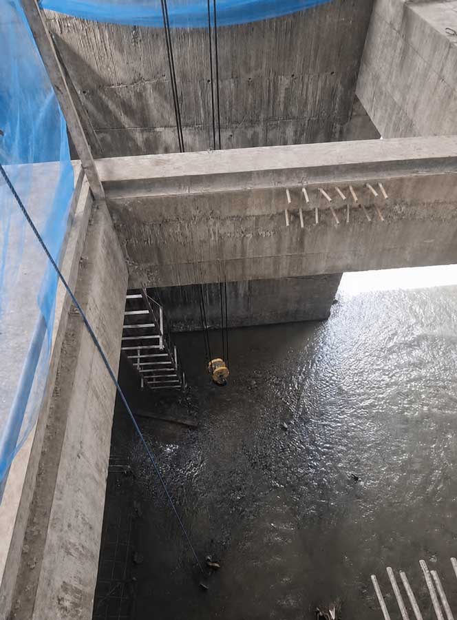 Crane hook lowered from the operating floor into the sluice gate chamber below