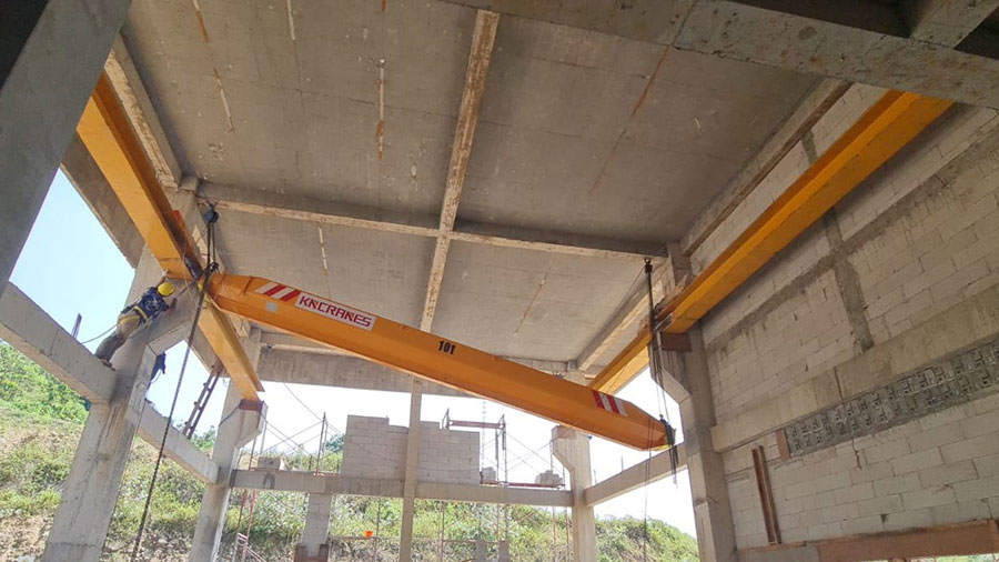 Site team installing the 10 ton single girder overhead crane on its runway beams