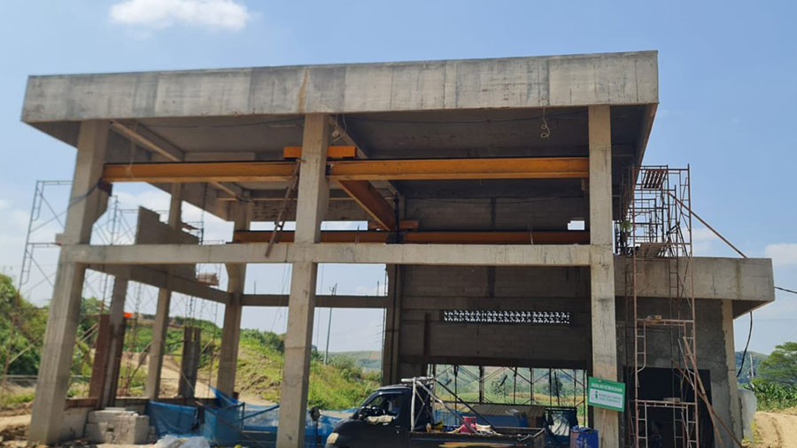 Concrete sluice gate house under construction on a water control structure in Indonesia