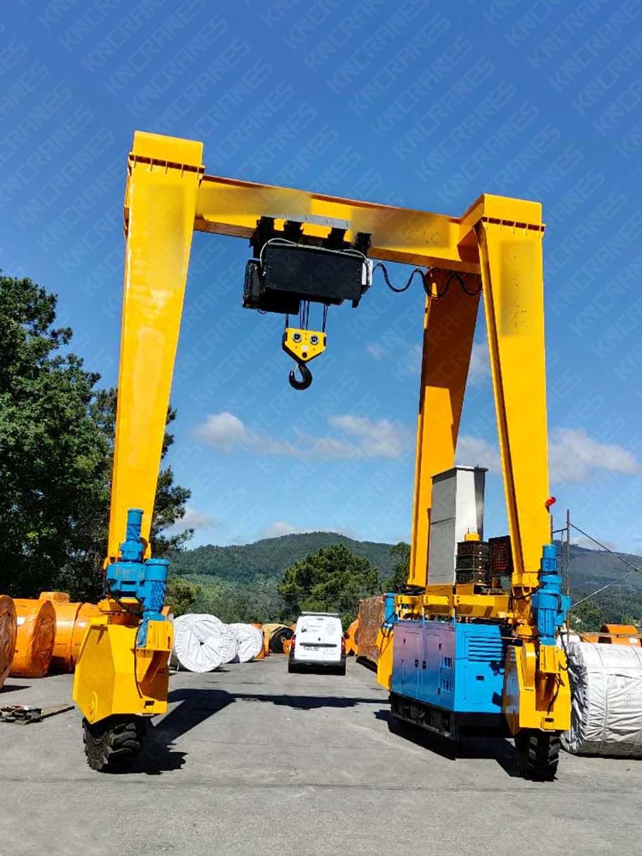 30 ton rubber tyred gantry crane standing over a narrow aisle between conveyor belt reel rows