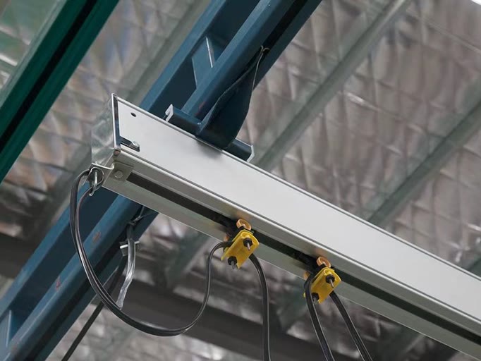 Aluminum crane rail end with cable trolleys