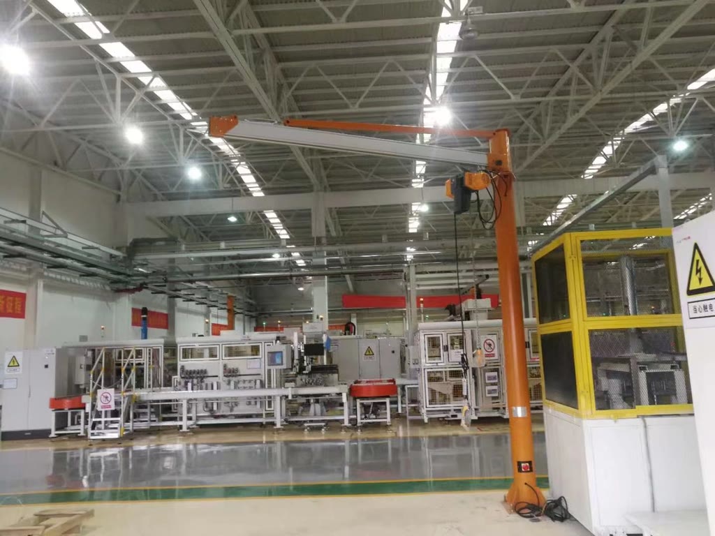 Pillar-mounted aluminum jib crane in a production workshop