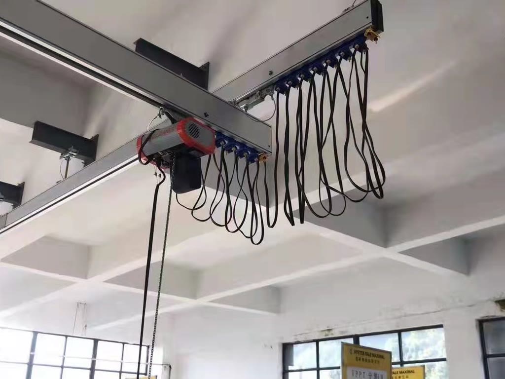 Ceiling-mounted aluminum rail crane with chain hoist and cable festoon